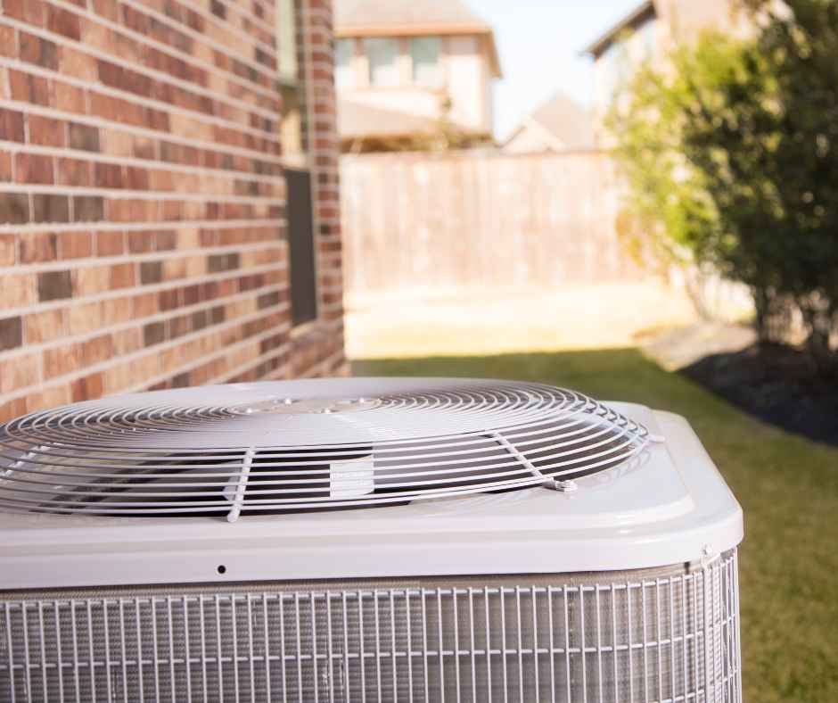 An air conditioning unit on the outside of a home An air conditioning unit on the outside of a home