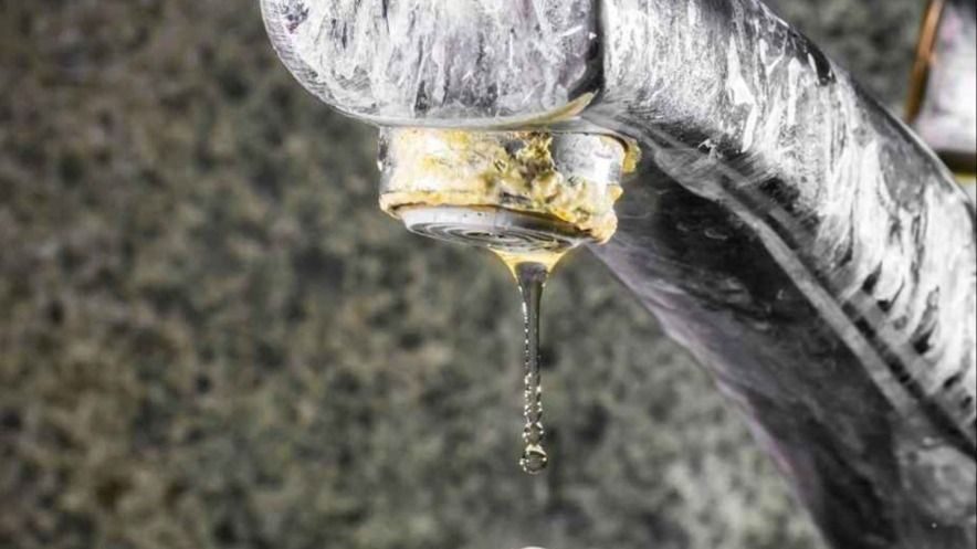 Signs of hard water buildup on a faucet