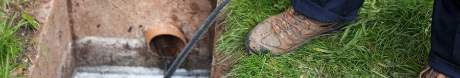 A professional inspecting a sewer line for maintenance purposes